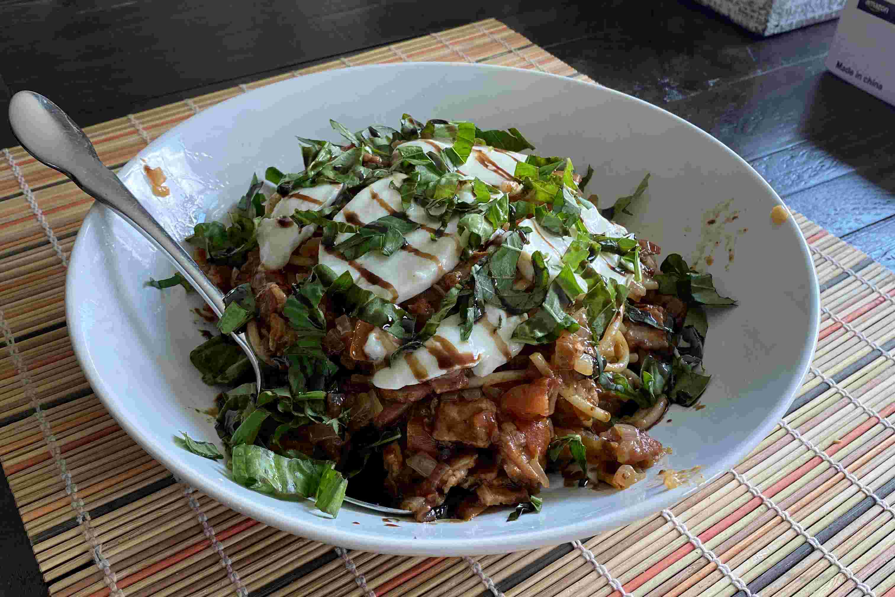 Caprese pasta topped with fresh mozzarella, basil, and balsamic glaze
